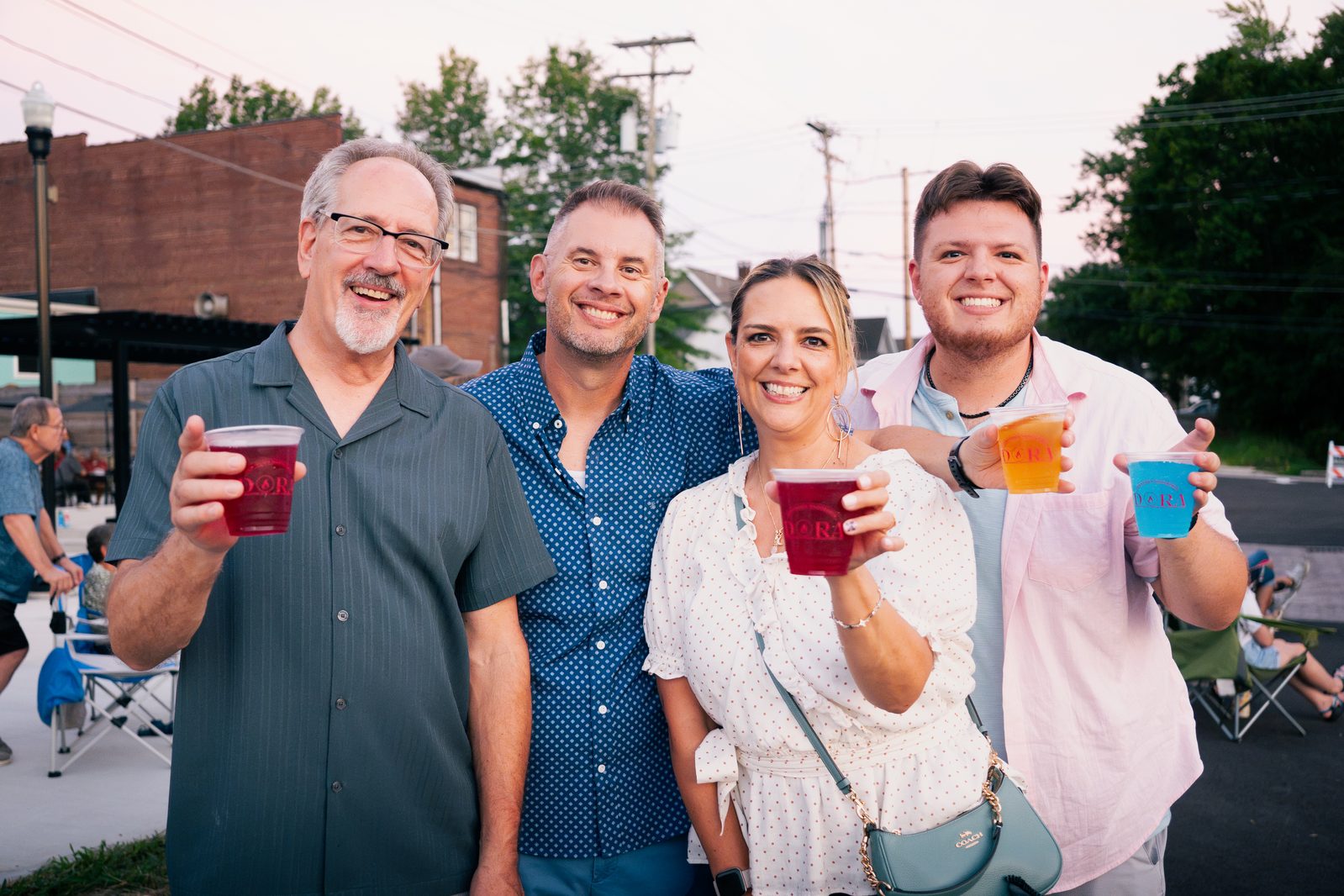 Group of friends toasting drinks at a Downtown Wadsworth festival