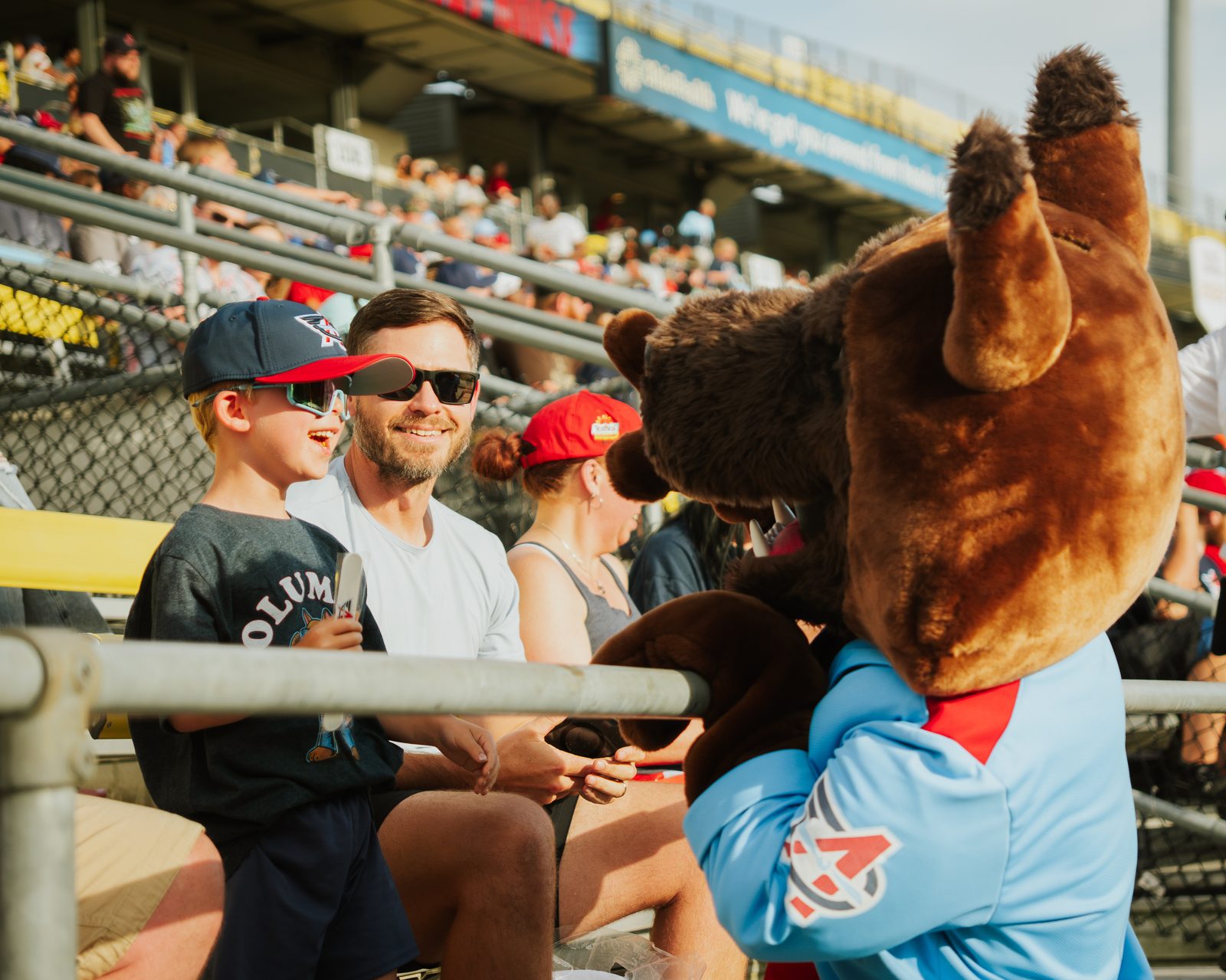 Family posing with the Aviators mascot in the stands