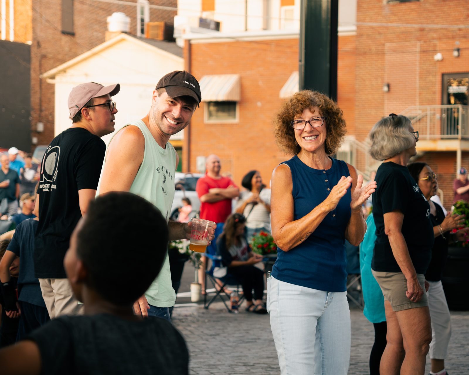 Guests laughing and clapping at a Downtown Wadsworth street festival